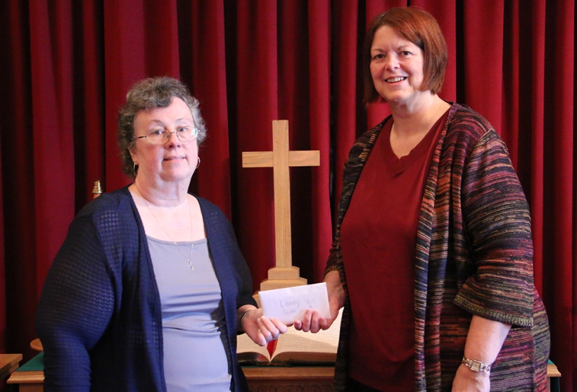 Pastor receives monies raised for missions.